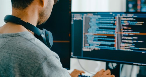 man looking at data on his computer 